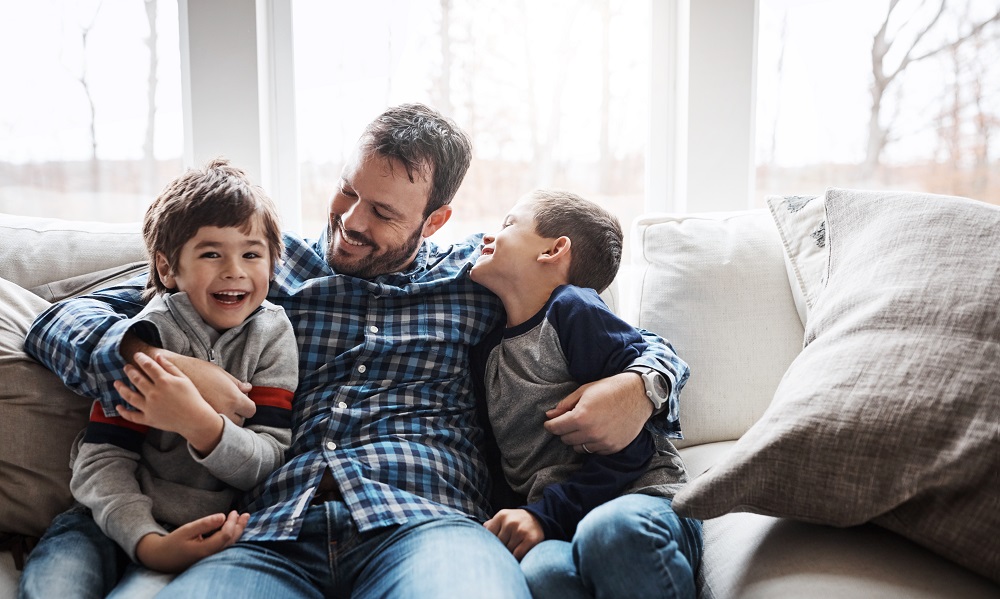 Vater mit seinen Kindern auf dem Sofa